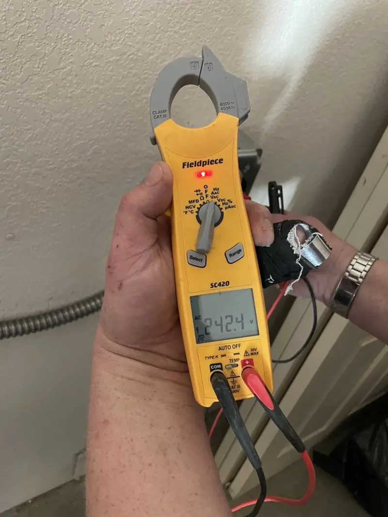 Voltage testing with clamp meter during Generator Installation in Fuller Heights